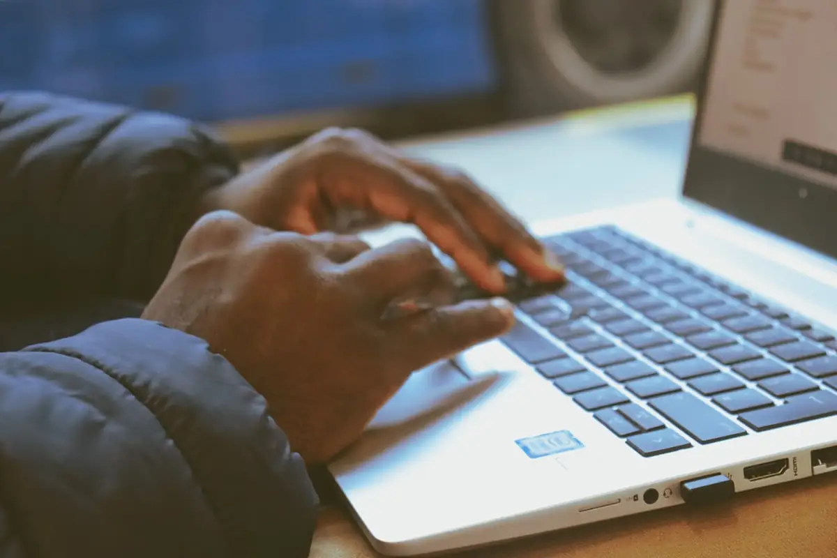 Someone typing at a laptop
