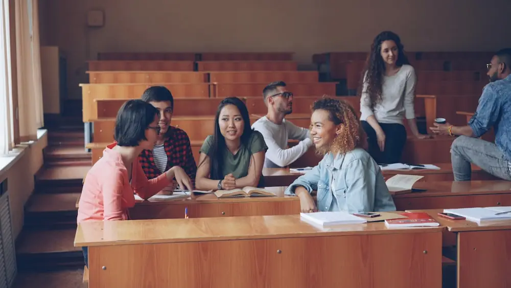 Students working together at a table in a lecture room