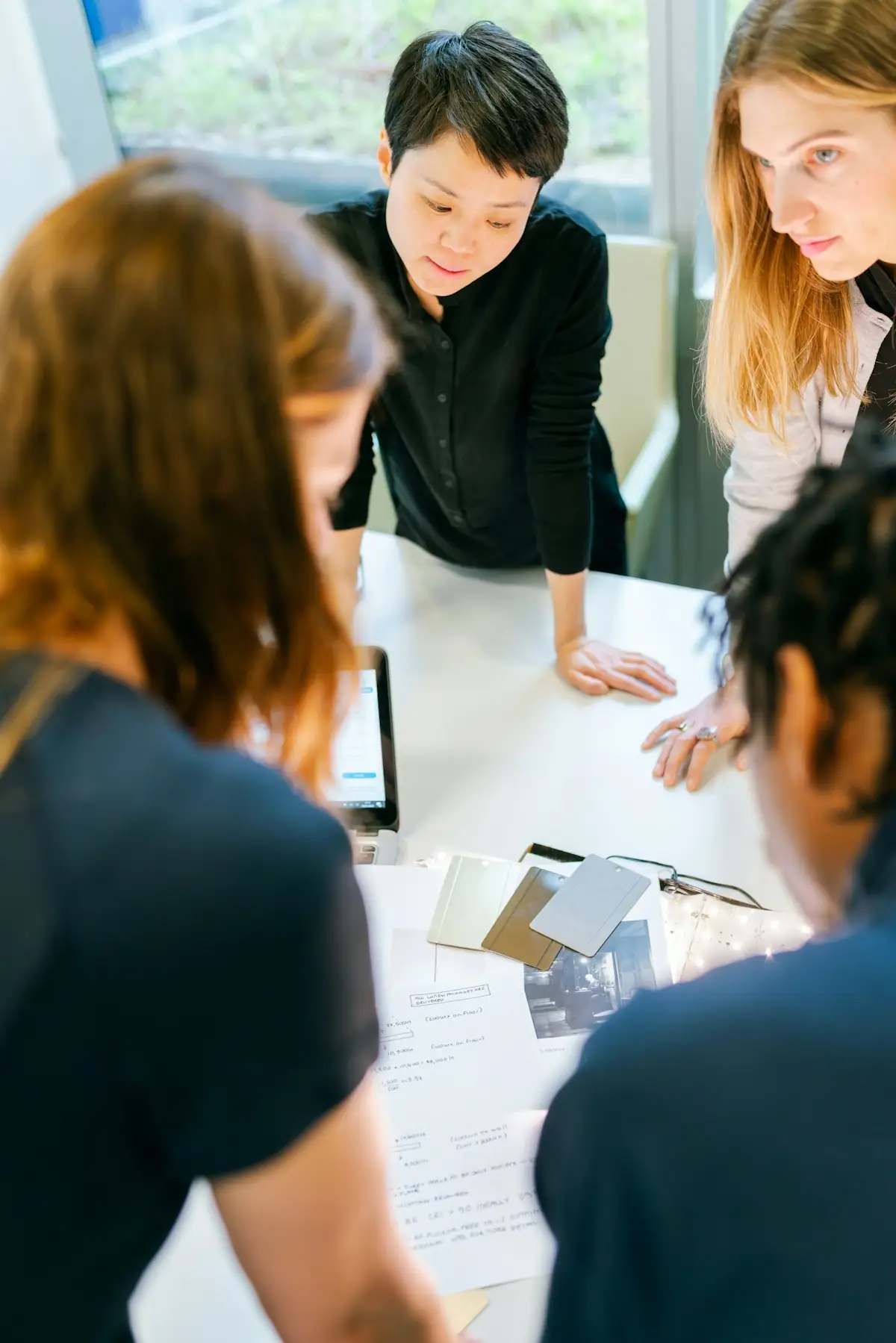 Four people reviewing documents together at a table