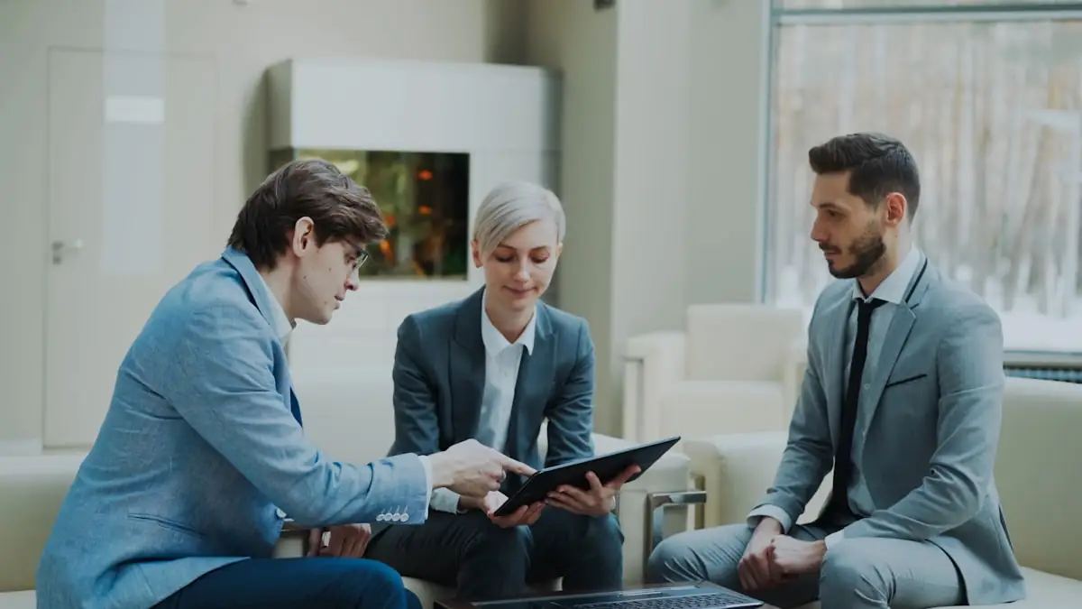 Colleagues discussing work on a tablet in an office